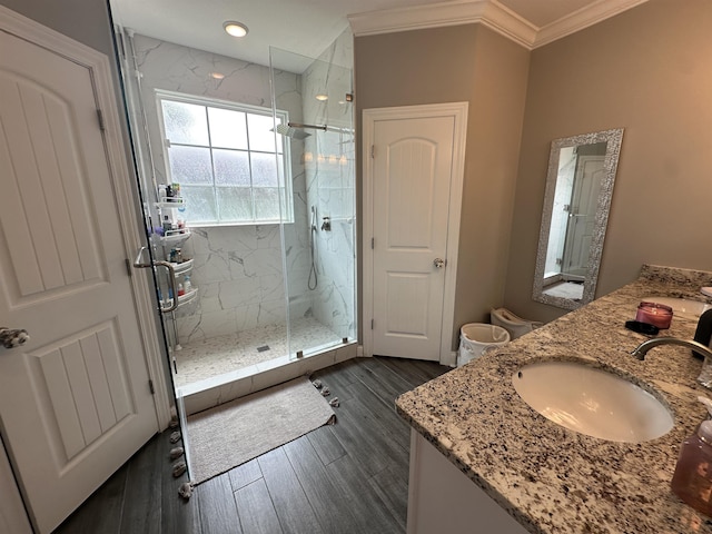 1008 Wildcat Ln, Jonesboro, AR 72405 - bathroom with a marble finish shower, double vanity, crown molding, and wood finished floors