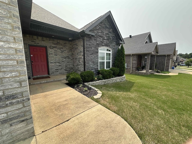 1008 Wildcat Ln, Jonesboro, AR 72405 - doorway to property with a lawn, roof with shingles, and brick siding