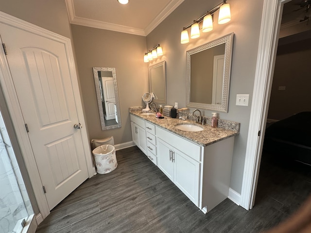 1008 Wildcat Ln, Jonesboro, AR 72405 - bathroom with double vanity, crown molding, baseboards, and wood finished floors