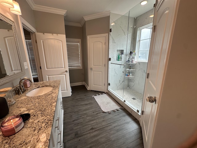 1008 Wildcat Ln, Jonesboro, AR 72405 - bathroom with a marble finish shower, ornamental molding, wood finished floors, vanity, and baseboards
