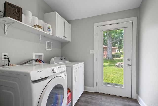1032 Virginia Ave, Bauxite, AR 72011 - laundry area featuring cabinet space, washer and clothes dryer, wood finished floors, and baseboards