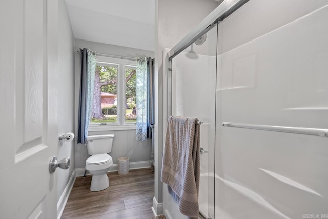 1032 Virginia Ave, Bauxite, AR 72011 - bathroom featuring baseboards, a shower stall, wood finished floors, and toilet