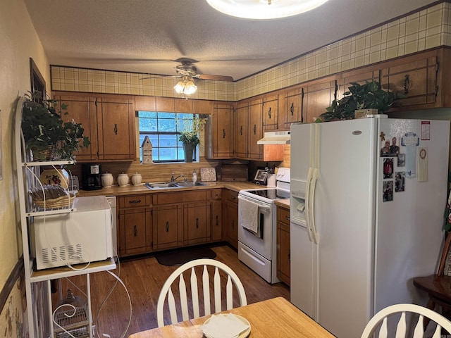 113 Boyd Rd, Southside, AR 72501 - kitchen with white appliances, under cabinet range hood, a sink, a ceiling fan, and brown cabinets