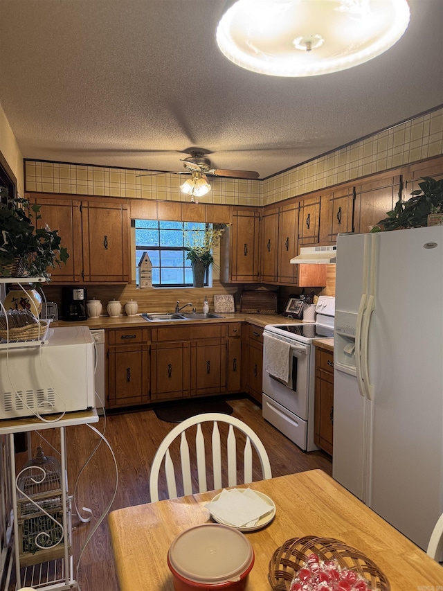 113 Boyd Rd, Southside, AR 72501 - kitchen featuring white appliances, under cabinet range hood, brown cabinetry, a sink, and a ceiling fan