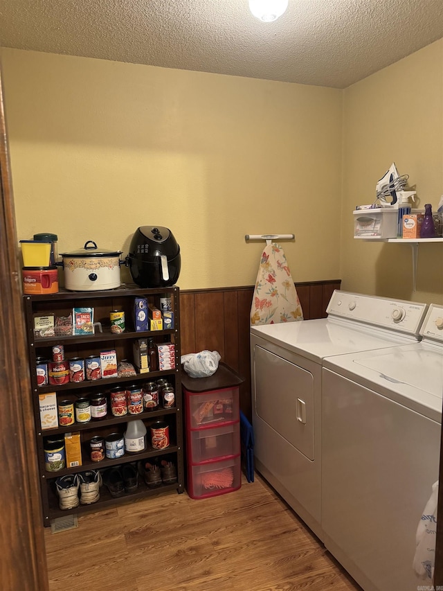 113 Boyd Rd, Southside, AR 72501 - washroom featuring washing machine and dryer, a wainscoted wall, wood finished floors, and a textured ceiling