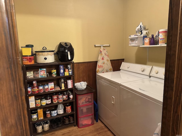 113 Boyd Rd, Southside, AR 72501 - laundry room with washer and clothes dryer, a wainscoted wall, and wood finished floors