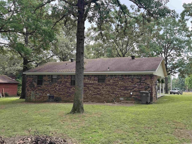 113 Boyd Rd, Southside, AR 72501 - rear view of house with a lawn, brick siding, and roof with shingles