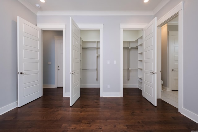 311 Parker St, North Little Rock, AR 72114 - unfurnished bedroom featuring baseboards, dark wood finished floors, multiple closets, recessed lighting, and crown molding