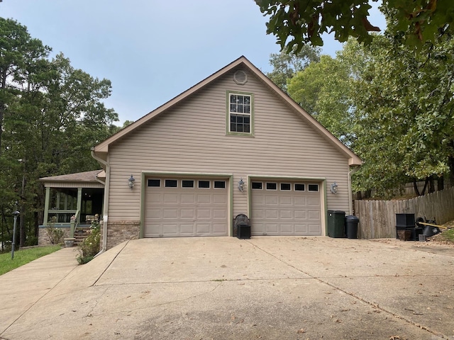 6 Maplewood W, Heber Springs, AR 72543 - view of property exterior featuring a garage, concrete driveway, and covered porch