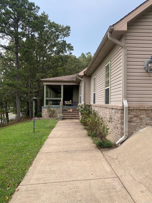 6 Maplewood W, Heber Springs, AR 72543 - doorway to property with a yard, covered porch, and brick siding