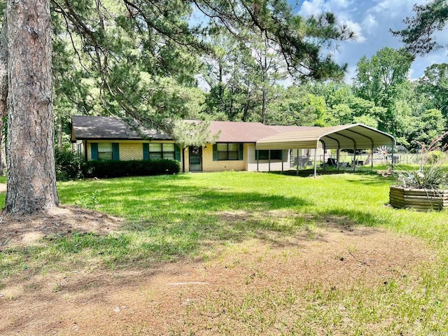 470 Lr 28, Foreman, AR 71836 - view of front of house featuring a front lawn, a detached carport, and brick siding