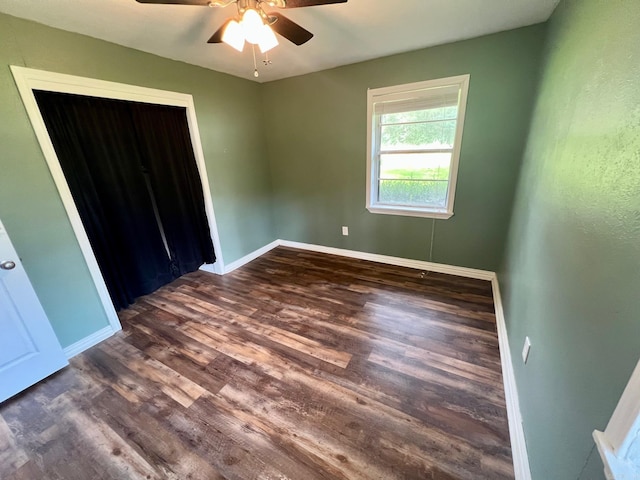 470 Lr 28, Foreman, AR 71836 - unfurnished bedroom featuring dark wood finished floors, baseboards, ceiling fan, and a closet