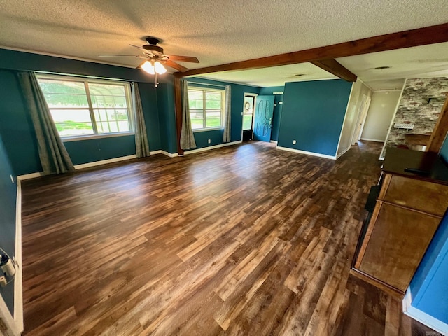470 Lr 28, Foreman, AR 71836 - empty room featuring a textured ceiling, ceiling fan, dark wood-style flooring, baseboards, and beamed ceiling