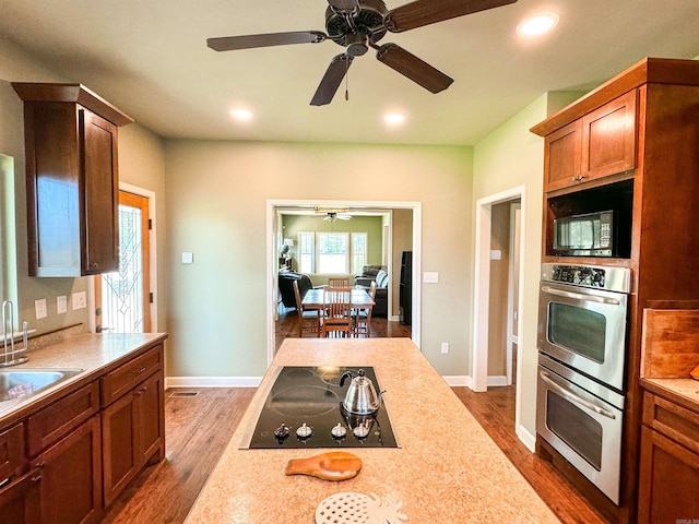 125 Gassaway, Searcy, AR 72143 - kitchen with black appliances, ceiling fan, light countertops, dark wood-type flooring, and recessed lighting