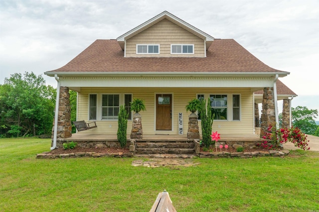 125 Gassaway, Searcy, AR 72143 - view of front facade featuring covered porch, a front yard, stone siding, and roof with shingles
