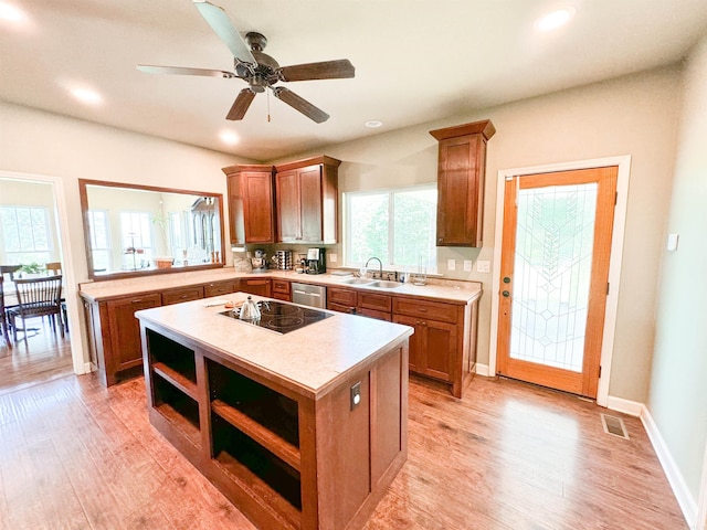 125 Gassaway, Searcy, AR 72143 - kitchen with black electric stovetop, open shelves, light countertops, a sink, and a center island