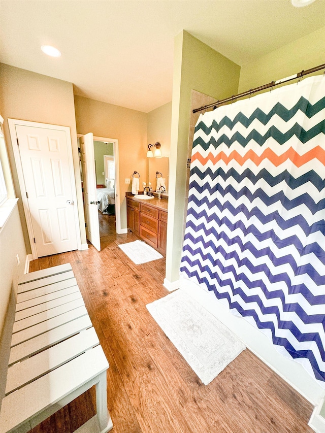 125 Gassaway, Searcy, AR 72143 - bathroom featuring wood finished floors, connected bathroom, a shower with shower curtain, vanity, and recessed lighting