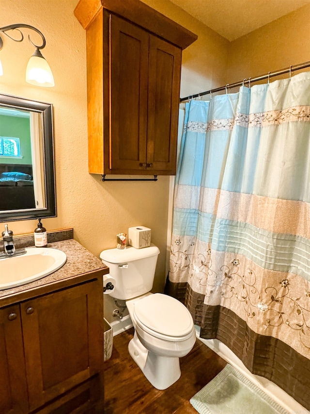 125 Gassaway, Searcy, AR 72143 - bathroom with vanity, toilet, wood finished floors, a textured wall, and curtained shower