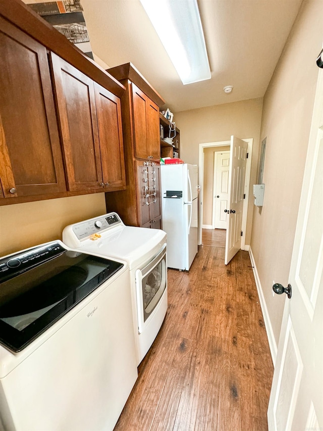 125 Gassaway, Searcy, AR 72143 - washroom featuring separate washer and dryer, cabinet space, light wood-style floors, and baseboards