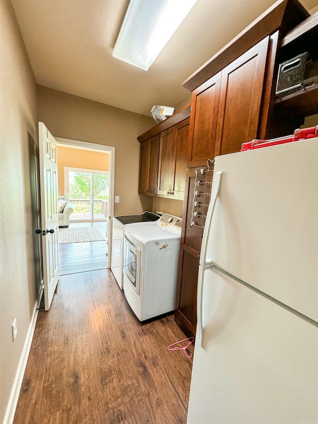 125 Gassaway, Searcy, AR 72143 - laundry room featuring cabinet space, dark wood-style flooring, washing machine and dryer, and baseboards