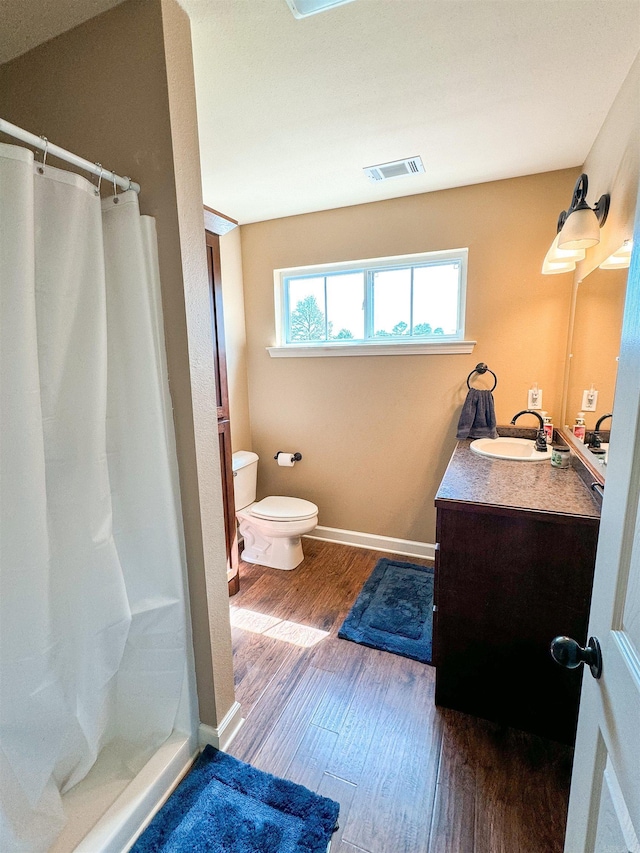 125 Gassaway, Searcy, AR 72143 - bathroom with wood finished floors, vanity, toilet, curtained shower, and baseboards