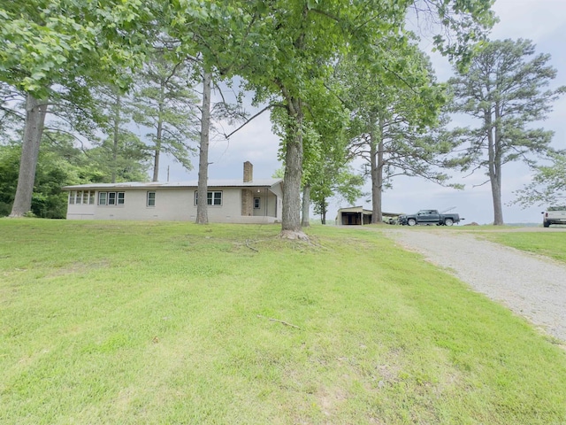 9689 W Ar 56th Hwy, Wideman, AR 72585 - view of side of property with gravel driveway, a chimney, and a yard