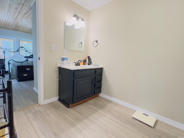 9689 W Ar 56th Hwy, Wideman, AR 72585 - bathroom with wood finished floors, baseboards, and vanity