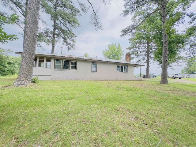 9689 W Ar 56th Hwy, Wideman, AR 72585 - back of house with a chimney and a lawn