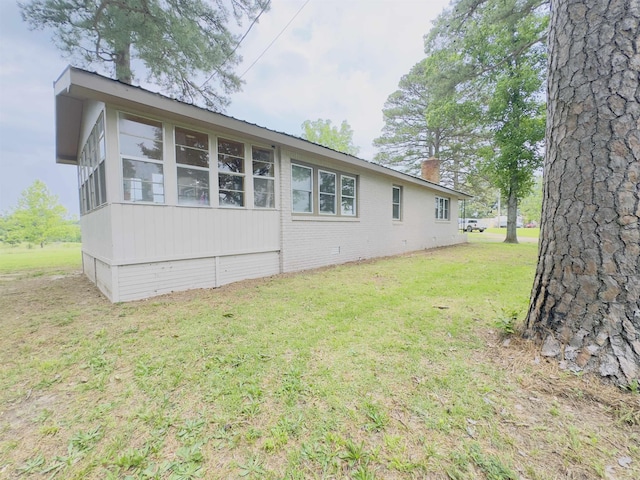 9689 W Ar 56th Hwy, Wideman, AR 72585 - view of home's exterior featuring a yard, a chimney, brick siding, and a sunroom