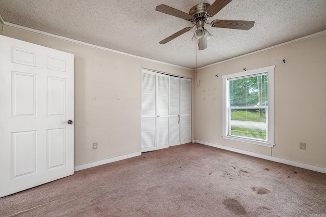 313 W Miller St, Gurdon, AR 71743 - unfurnished bedroom with a textured ceiling, ornamental molding, carpet floors, a closet, and baseboards