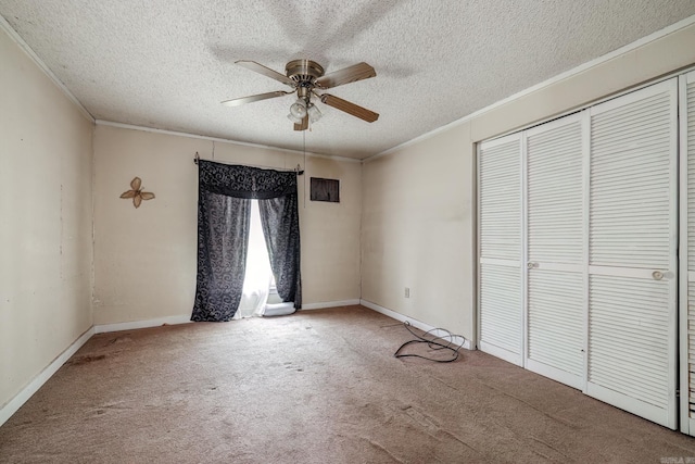 313 W Miller St, Gurdon, AR 71743 - unfurnished bedroom with ornamental molding, carpet flooring, a textured ceiling, a closet, and baseboards