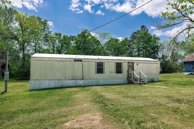 313 W Miller St, Gurdon, AR 71743 - rear view of house featuring a lawn