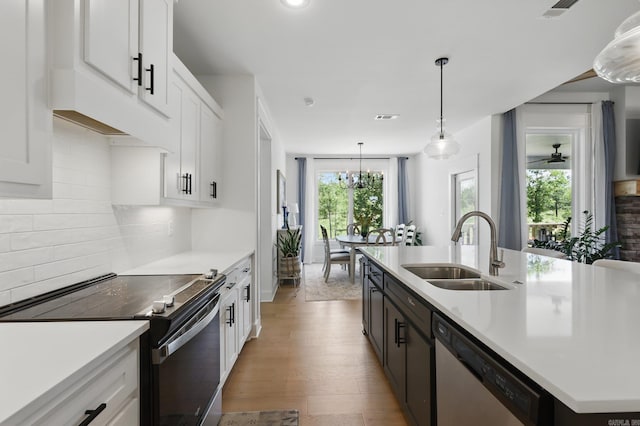 10584 Gunter Loop, Benton, AR 72019 - kitchen with range with electric stovetop, stainless steel dishwasher, a sink, white cabinets, and light wood-style floors