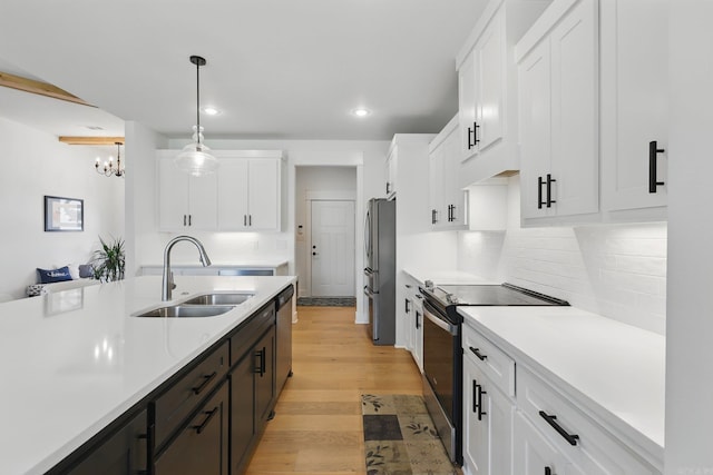 10584 Gunter Loop, Benton, AR 72019 - kitchen featuring appliances with stainless steel finishes, a sink, light countertops, white cabinetry, and recessed lighting