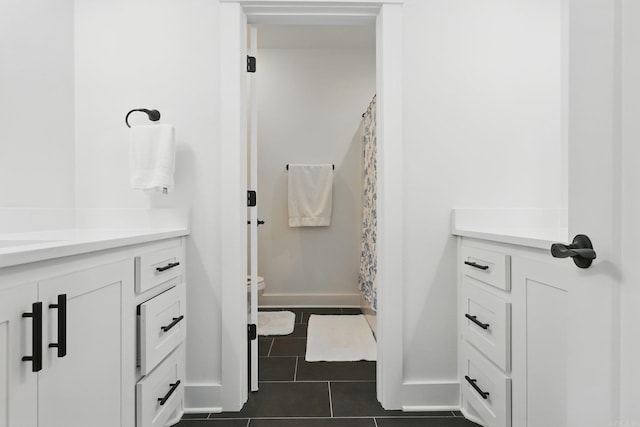 10584 Gunter Loop, Benton, AR 72019 - full bathroom with vanity, toilet, tile patterned floors, baseboards, and a shower with shower curtain