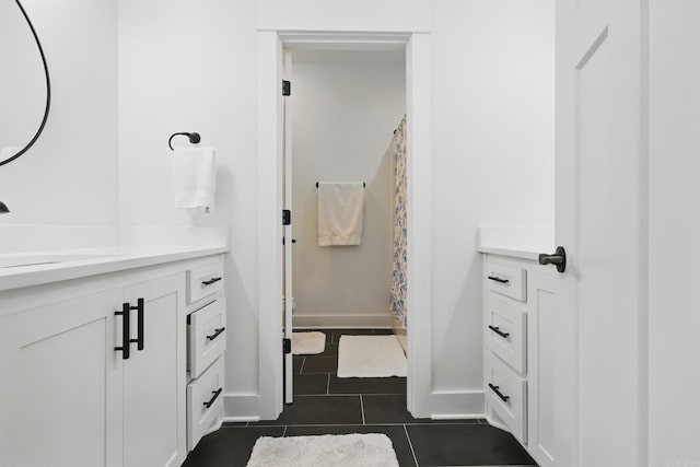 10584 Gunter Loop, Benton, AR 72019 - bathroom featuring vanity, tile patterned floors, baseboards, and curtained shower