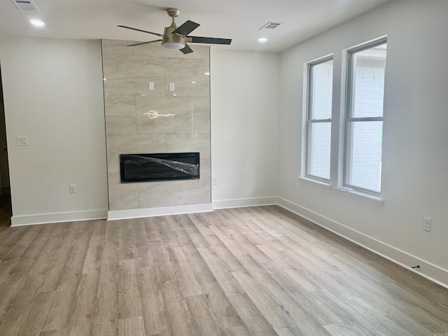 12409 Styles Rd, Bauxite, AR 72011 - unfurnished living room with a ceiling fan, a tile fireplace, wood finished floors, baseboards, and recessed lighting