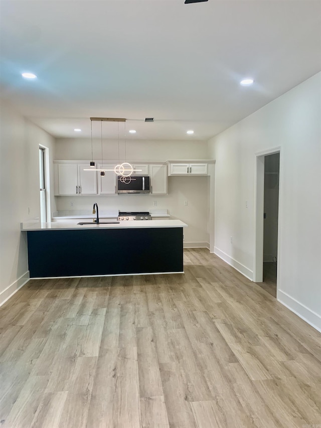 12409 Styles Rd, Bauxite, AR 72011 - kitchen with stainless steel microwave, white cabinetry, recessed lighting, and light countertops