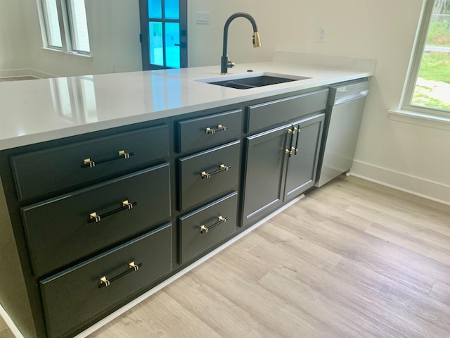 12409 Styles Rd, Bauxite, AR 72011 - kitchen featuring dishwasher, a sink, light countertops, and light wood finished floors