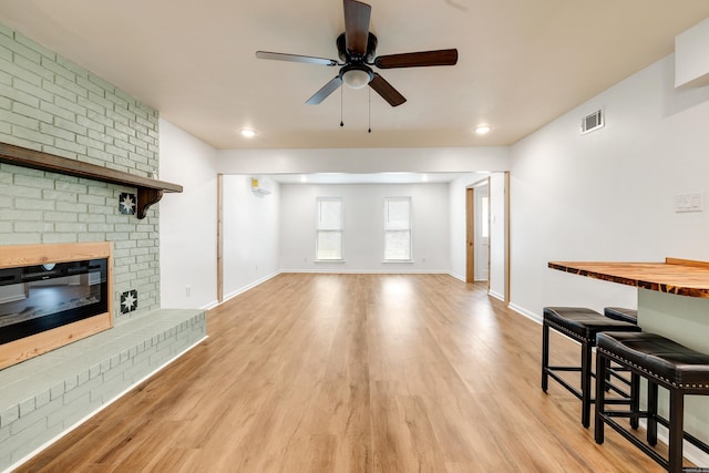 3316 Carmine Cv, Bryant, AR 72202 - living area featuring ceiling fan, light wood finished floors, baseboards, a brick fireplace, and recessed lighting