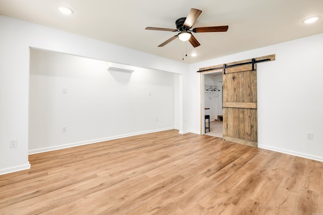 3316 Carmine Cv, Bryant, AR 72202 - unfurnished bedroom featuring a barn door, light wood-style flooring, recessed lighting, and baseboards