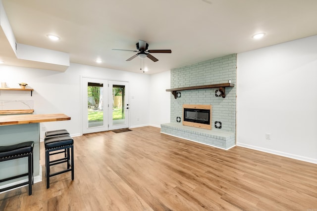 3316 Carmine Cv, Bryant, AR 72202 - unfurnished living room featuring ceiling fan, light wood-style flooring, baseboards, recessed lighting, and a brick fireplace
