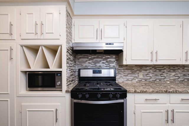122 Glen Dr, Little Rock, AR 72207 - kitchen featuring stainless steel appliances, under cabinet range hood, white cabinets, backsplash, and light stone countertops