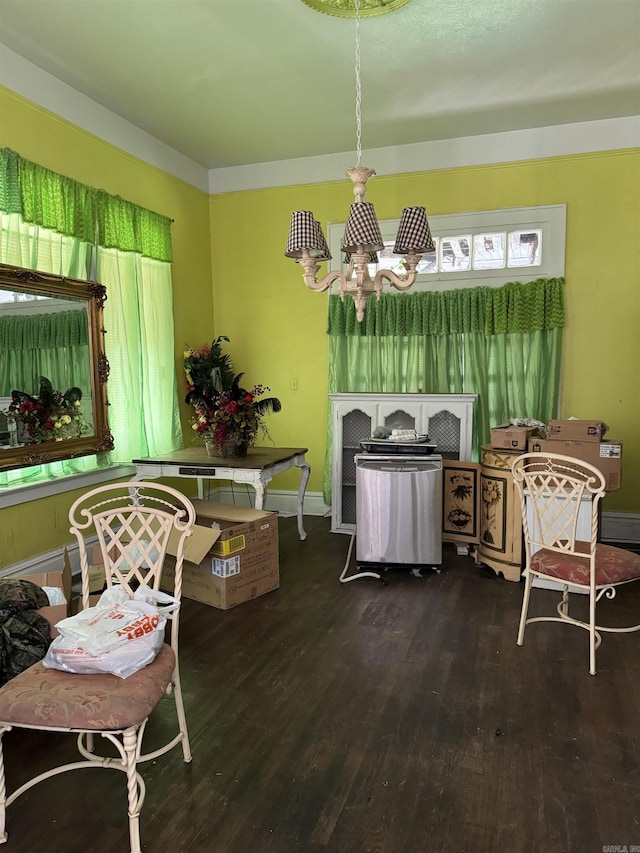 211 California Ave, Camden, AR 71701 - dining area with wood finished floors, a chandelier, and baseboards
