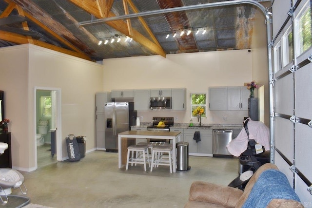 312 Broken Bow Trl, Lonsdale, AR 72087 - living room with high vaulted ceiling, finished concrete flooring, baseboards, and beam ceiling