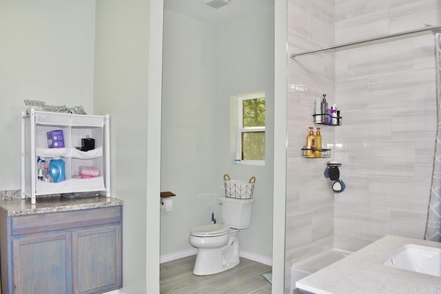 312 Broken Bow Trl, Lonsdale, AR 72087 - full bathroom featuring toilet, tiled shower, vanity, and baseboards