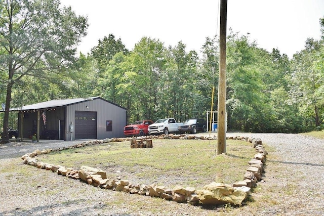 312 Broken Bow Trl, Lonsdale, AR 72087 - view of yard featuring a detached garage and an outbuilding