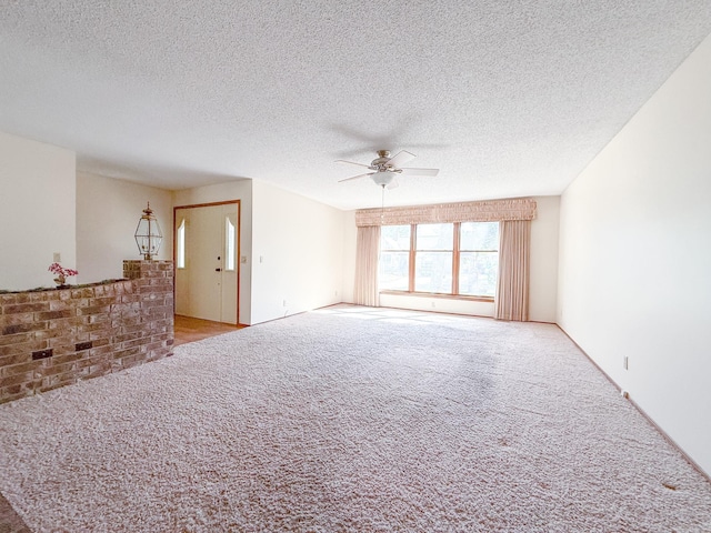 1908 Honeysuckle Dr, Mountain Home, AR 72653 - unfurnished living room featuring a ceiling fan, carpet flooring, and a textured ceiling