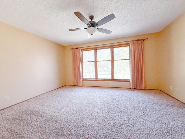 1908 Honeysuckle Dr, Mountain Home, AR 72653 - unfurnished room featuring a ceiling fan, light carpet, a textured ceiling, and baseboards