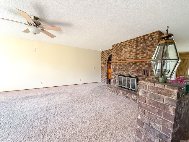 1908 Honeysuckle Dr, Mountain Home, AR 72653 - unfurnished living room with ceiling fan, a brick fireplace, carpet flooring, and a textured ceiling